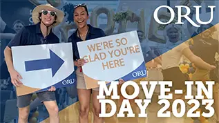 Video Thumbnail showing two students smiling holding signs with a caption under them reading, 'Move-in Day 2023'.