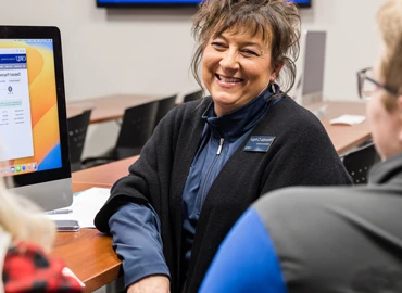 Person at desk with computer in office setting.