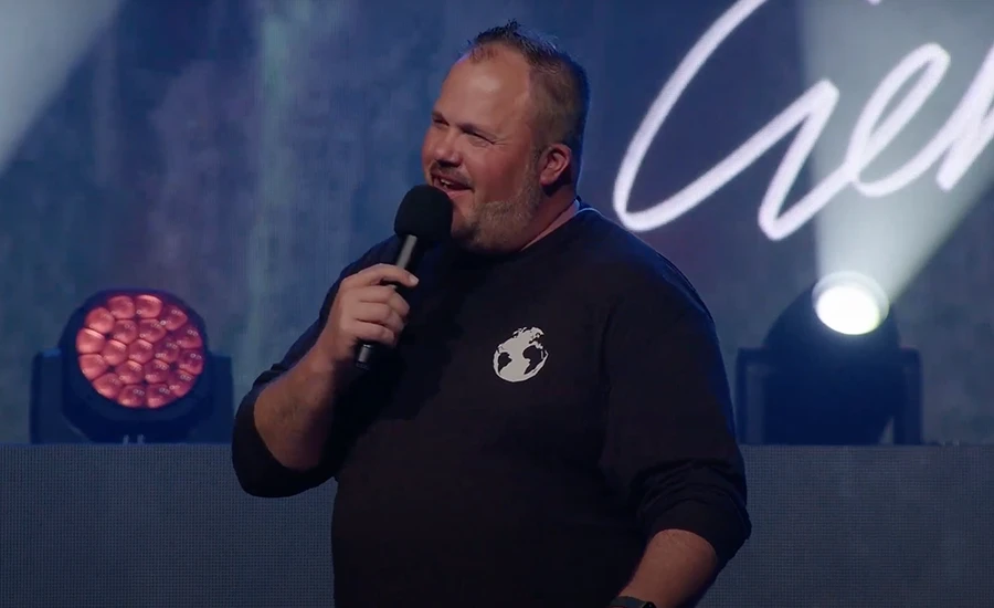 Pastor Dustin Smith Preaching with a microphone in his hand