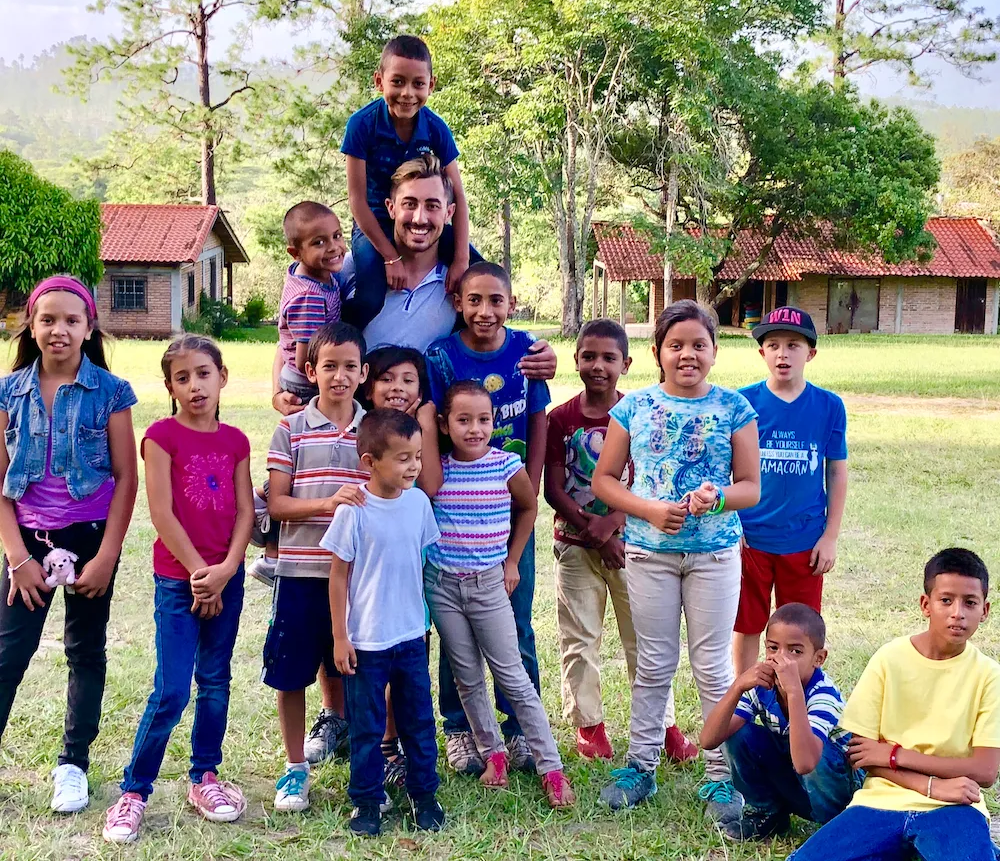 Michael Weitzman pictured with children he served while on a mission trip in Ecuador.
