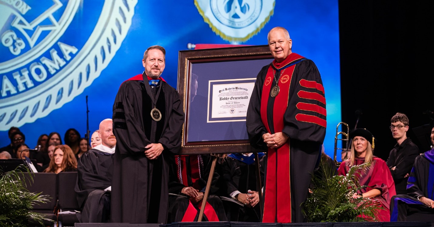 Dr. Wilson presents Commencement speaker Bobby Gruenewald  with an honorary Doctor of Divinity