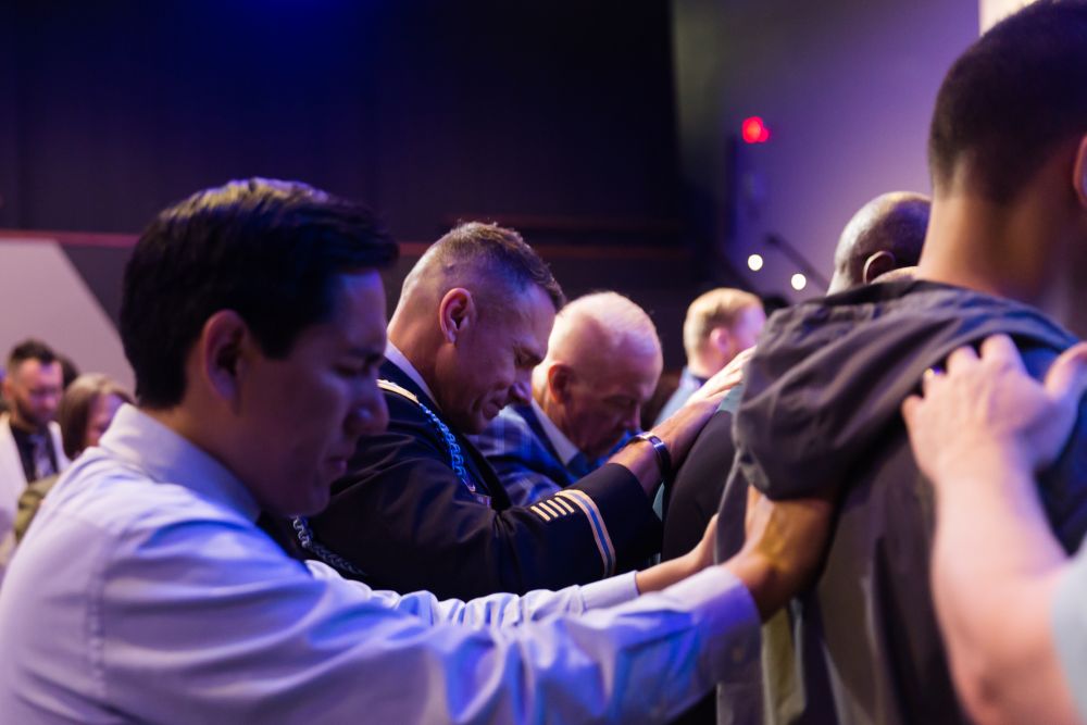 Men praying in ministry. 