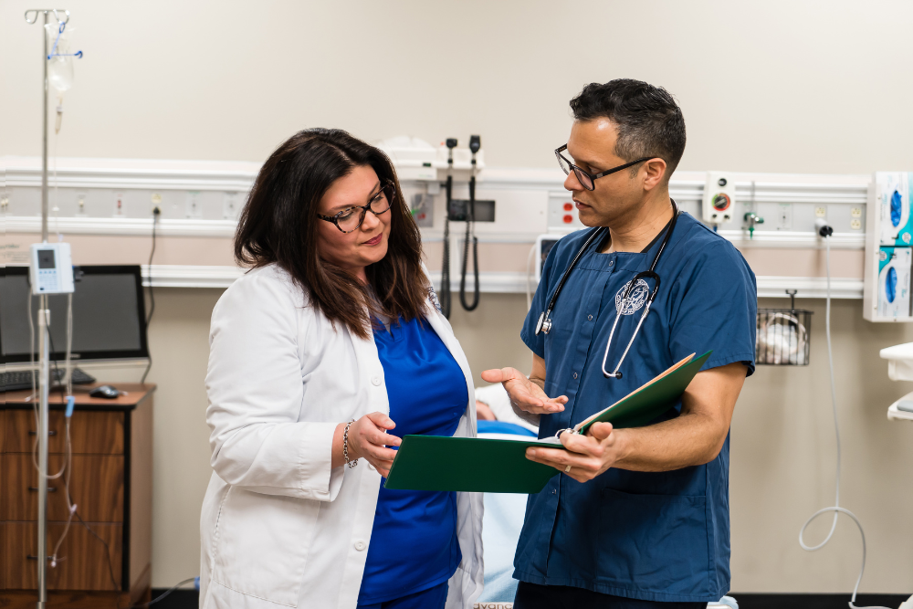Nursing professionals reviewing patient care plans in a clinical setting.